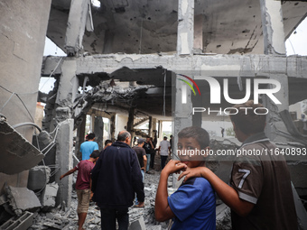 People inspect the damage to a mosque after it is hit in an Israeli strike in Deir al-Balah, central Gaza Strip, on October 6, 2024, amid th...