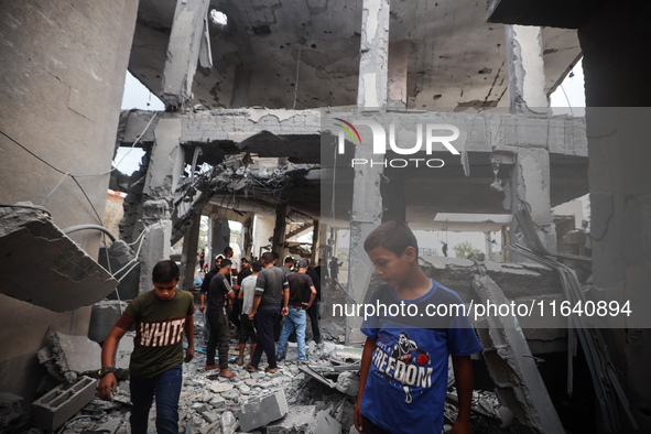 People inspect the damage to a mosque after it is hit in an Israeli strike in Deir al-Balah, central Gaza Strip, on October 6, 2024, amid th...