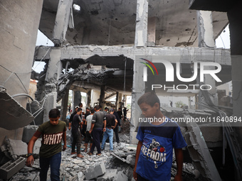 People inspect the damage to a mosque after it is hit in an Israeli strike in Deir al-Balah, central Gaza Strip, on October 6, 2024, amid th...