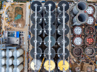 Workers work at the construction site of the first phase of the Hualian grain storage and logistics project at Huangma Port in Huaian City,...