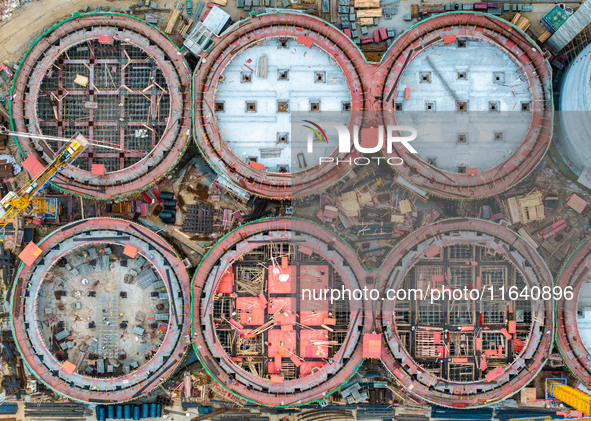 Workers work at the construction site of the first phase of the Hualian grain storage and logistics project at Huangma Port in Huaian City,...