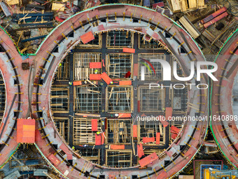 Workers work at the construction site of the first phase of the Hualian grain storage and logistics project at Huangma Port in Huaian City,...