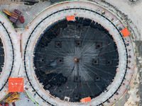 Workers work at the construction site of the first phase of the Hualian grain storage and logistics project at Huangma Port in Huaian City,...