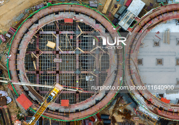 Workers work at the construction site of the first phase of the Hualian grain storage and logistics project at Huangma Port in Huaian City,...