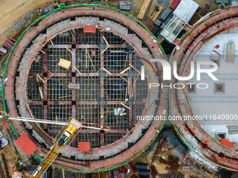 Workers work at the construction site of the first phase of the Hualian grain storage and logistics project at Huangma Port in Huaian City,...