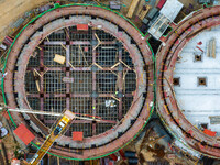 Workers work at the construction site of the first phase of the Hualian grain storage and logistics project at Huangma Port in Huaian City,...