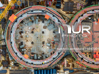 Workers work at the construction site of the first phase of the Hualian grain storage and logistics project at Huangma Port in Huaian City,...