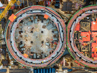 Workers work at the construction site of the first phase of the Hualian grain storage and logistics project at Huangma Port in Huaian City,...