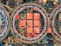 Workers work at the construction site of the first phase of the Hualian grain storage and logistics project at Huangma Port in Huaian City,...