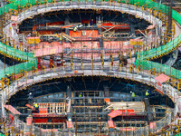 Workers work at the construction site of the first phase of the Hualian grain storage and logistics project at Huangma Port in Huaian City,...