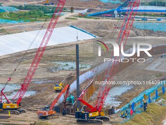 Workers work at the construction site of the Huaian Junction project of the second phase of the Huaihe River Waterway into the sea in Huai'a...