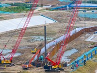 Workers work at the construction site of the Huaian Junction project of the second phase of the Huaihe River Waterway into the sea in Huai'a...