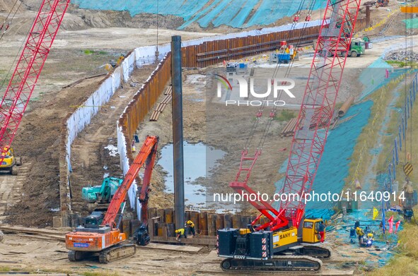 Workers work at the construction site of the Huaian Junction project of the second phase of the Huaihe River Waterway into the sea in Huai'a...