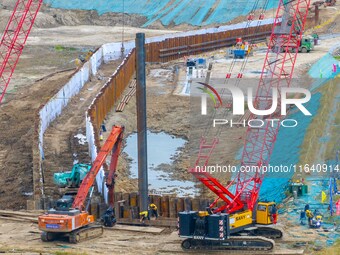 Workers work at the construction site of the Huaian Junction project of the second phase of the Huaihe River Waterway into the sea in Huai'a...