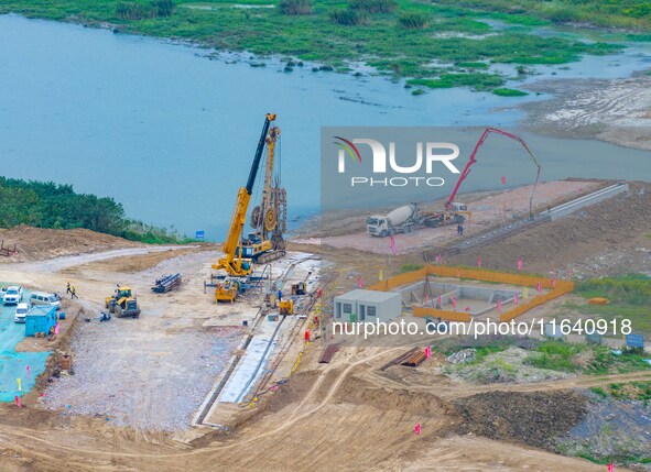 Workers work at the construction site of the Huaian Junction project of the second phase of the Huaihe River Waterway into the sea in Huai'a...