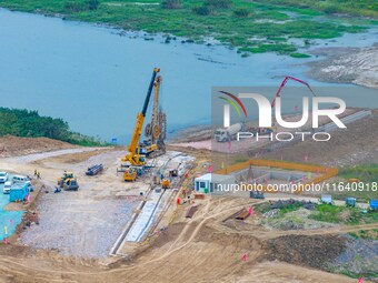 Workers work at the construction site of the Huaian Junction project of the second phase of the Huaihe River Waterway into the sea in Huai'a...