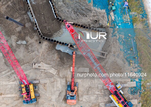 Workers work at the construction site of the Huaian Junction project of the second phase of the Huaihe River Waterway into the sea in Huai'a...