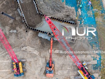 Workers work at the construction site of the Huaian Junction project of the second phase of the Huaihe River Waterway into the sea in Huai'a...