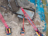 Workers work at the construction site of the Huaian Junction project of the second phase of the Huaihe River Waterway into the sea in Huai'a...