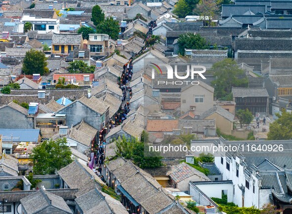 Tourists visit the Riverside Ancient Town in Huai'an, China, on October 5, 2024. 