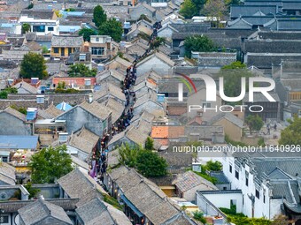 Tourists visit the Riverside Ancient Town in Huai'an, China, on October 5, 2024. (