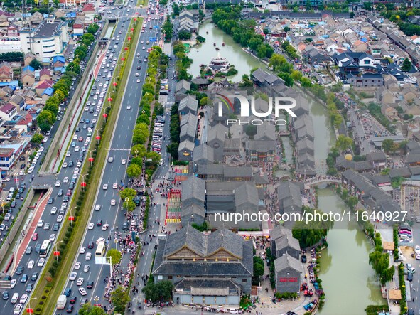 Tourists visit the Riverside Ancient Town in Huai'an, China, on October 5, 2024. 