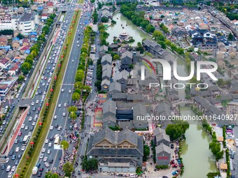 Tourists visit the Riverside Ancient Town in Huai'an, China, on October 5, 2024. (