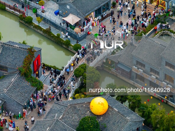 Tourists visit the Riverside Ancient Town in Huai'an, China, on October 5, 2024. 