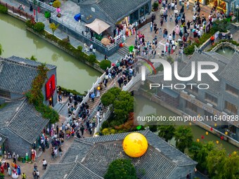 Tourists visit the Riverside Ancient Town in Huai'an, China, on October 5, 2024. (