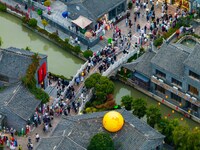 Tourists visit the Riverside Ancient Town in Huai'an, China, on October 5, 2024. (