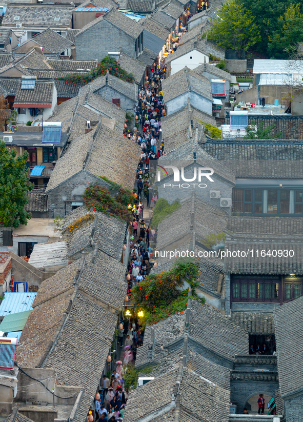 Tourists visit the Riverside Ancient Town in Huai'an, China, on October 5, 2024. 