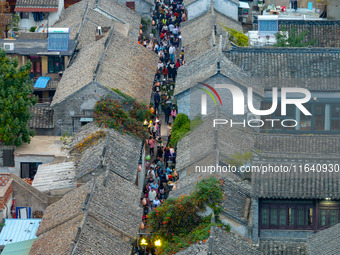 Tourists visit the Riverside Ancient Town in Huai'an, China, on October 5, 2024. (