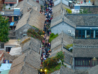 Tourists visit the Riverside Ancient Town in Huai'an, China, on October 5, 2024. (