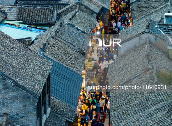 Tourists visit the Riverside Ancient Town in Huai'an, China, on October 5, 2024. 