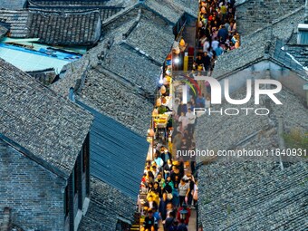 Tourists visit the Riverside Ancient Town in Huai'an, China, on October 5, 2024. (