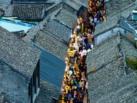 Tourists visit the Riverside Ancient Town in Huai'an, China, on October 5, 2024. (