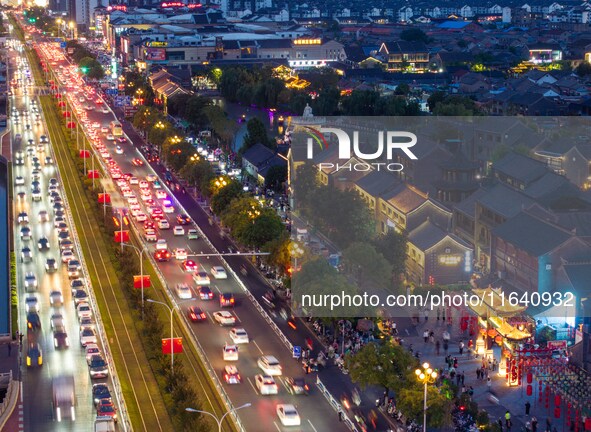 Tourists visit the Riverside Ancient Town in Huai'an, China, on October 5, 2024. 