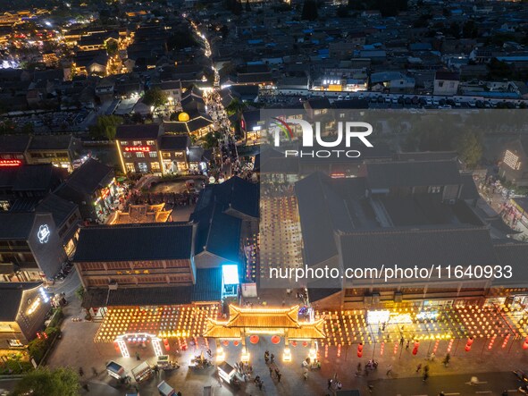 Tourists visit the Riverside Ancient Town in Huai'an, China, on October 5, 2024. 