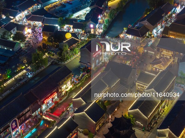 Tourists visit the Riverside Ancient Town in Huai'an, China, on October 5, 2024. 