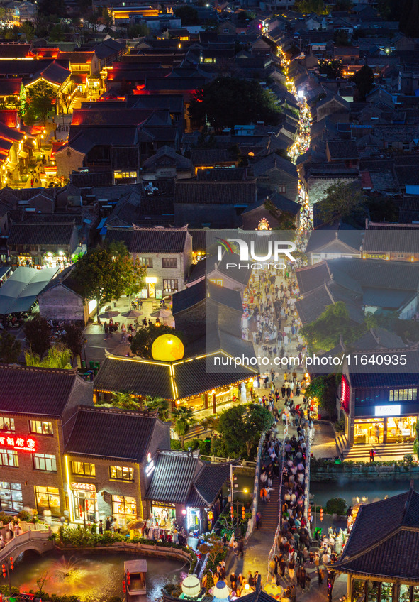 Tourists visit the Riverside Ancient Town in Huai'an, China, on October 5, 2024. 