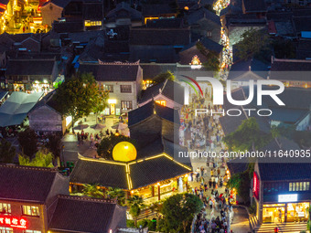 Tourists visit the Riverside Ancient Town in Huai'an, China, on October 5, 2024. (