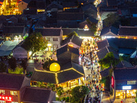 Tourists visit the Riverside Ancient Town in Huai'an, China, on October 5, 2024. (