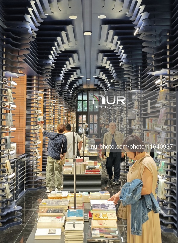 Visitors visit Zhongshuge Bookstore, the first bookstore to open in Tianjin, China, on September 30, 2024. 