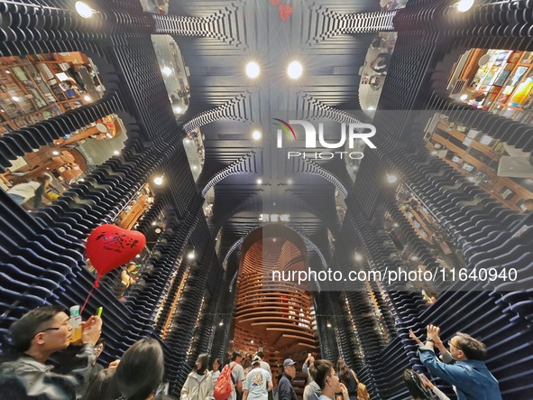 Visitors visit Zhongshuge Bookstore, the first bookstore to open in Tianjin, China, on September 30, 2024. 