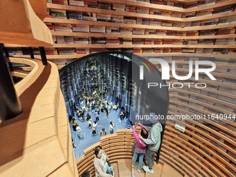 Visitors visit Zhongshuge Bookstore, the first bookstore to open in Tianjin, China, on September 30, 2024. (