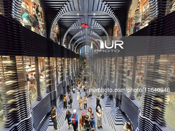 Visitors visit Zhongshuge Bookstore, the first bookstore to open in Tianjin, China, on September 30, 2024. 