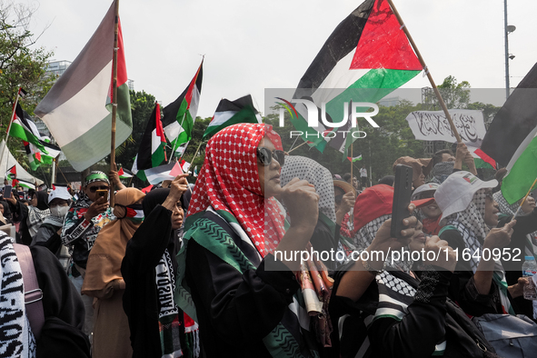 Pro-Palestinian demonstrators hold a protest marking the one-year anniversary of the Israel-Hamas conflict in front of the US Embassy in Jak...