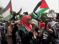 Pro-Palestinian demonstrators hold a protest marking the one-year anniversary of the Israel-Hamas conflict in front of the US Embassy in Jak...