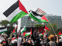 Pro-Palestinian demonstrators carry Palestinian flags during a protest marking the one-year anniversary of the Israel-Hamas conflict in fron...