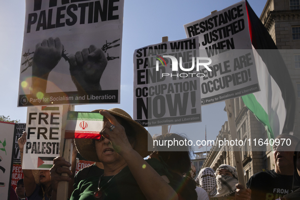 A person shows an Iranian flag during a pro-Palestinian rally as part of an international day of action near the White House in Washington D...